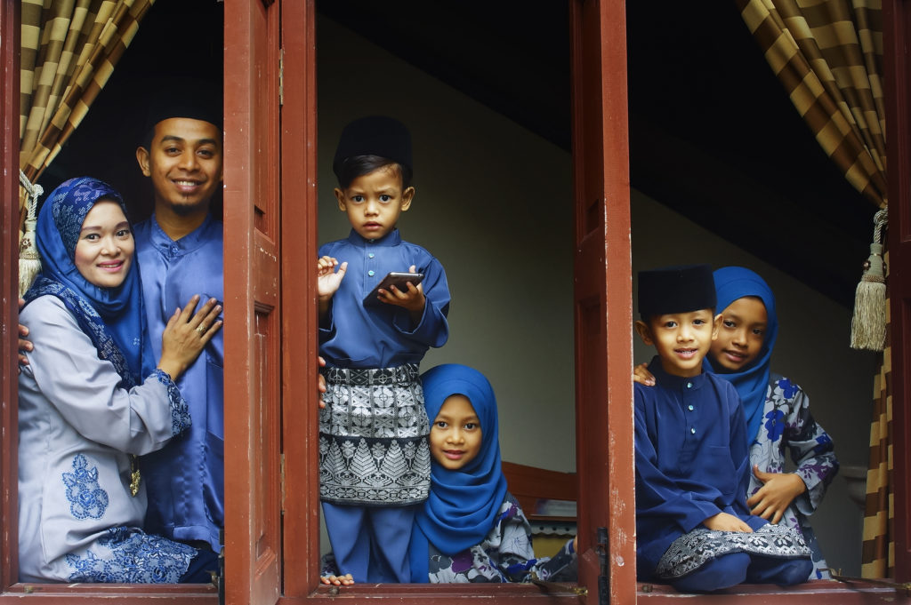 family in blue baju raya clothes