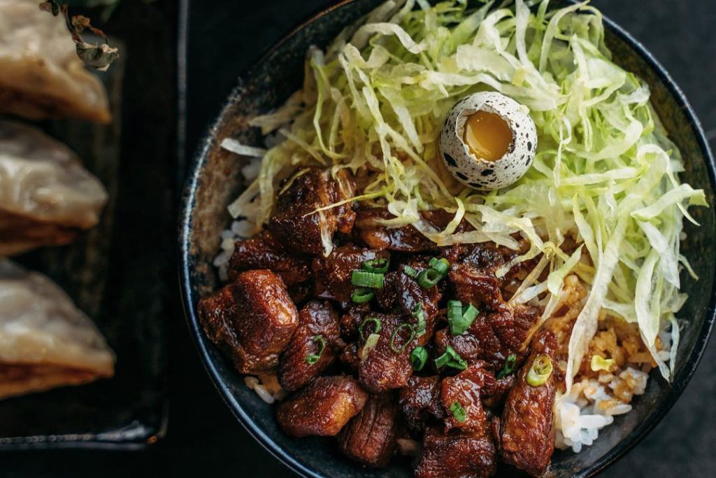 Braised pork belly rice with lettuce and egg atop