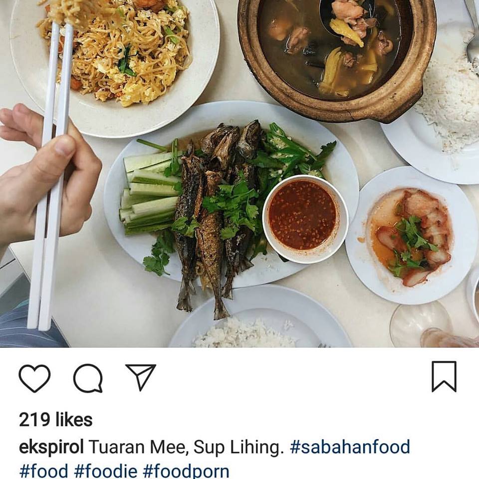 Dishes on table at Restoran Ah Soon Kor with hand holding chopsticks on side