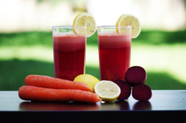 2 glasses of carrot, lemon & beets juice on table