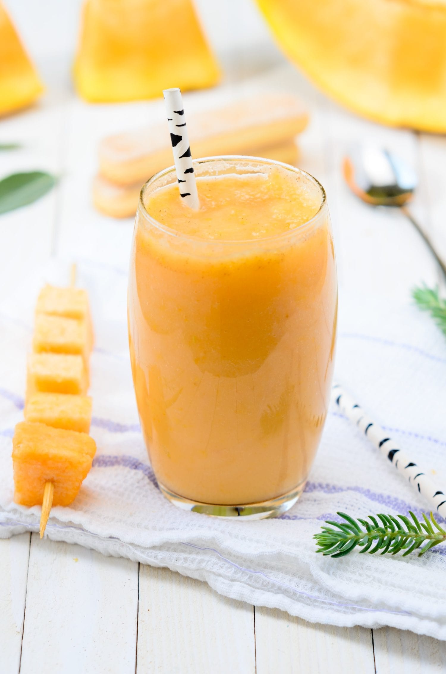 Pineapple carrot juice in glass on white table