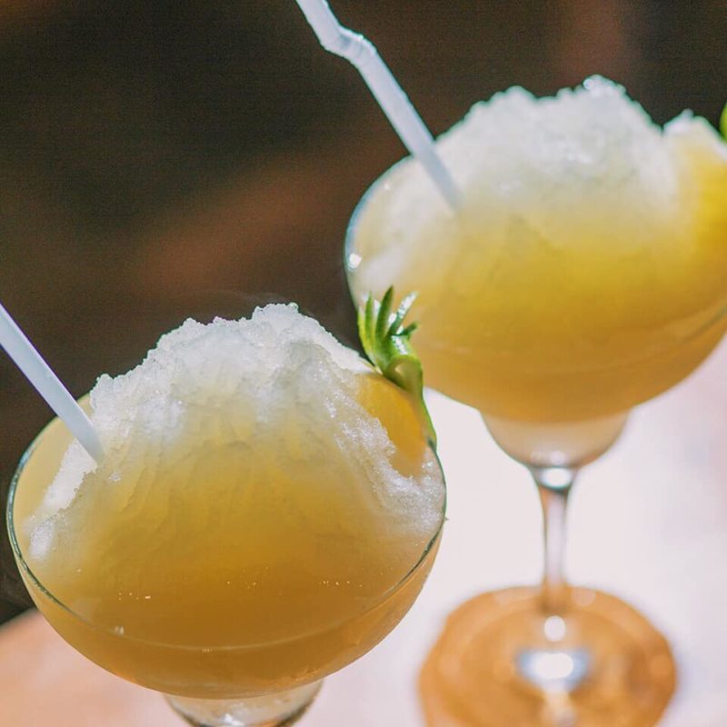 2 orange cocktails with straw