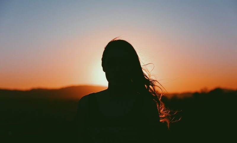 Girl's silhouette in the setting sun