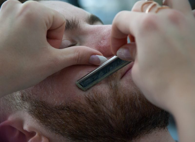 Premium Barbers Close cut shave of bearded man