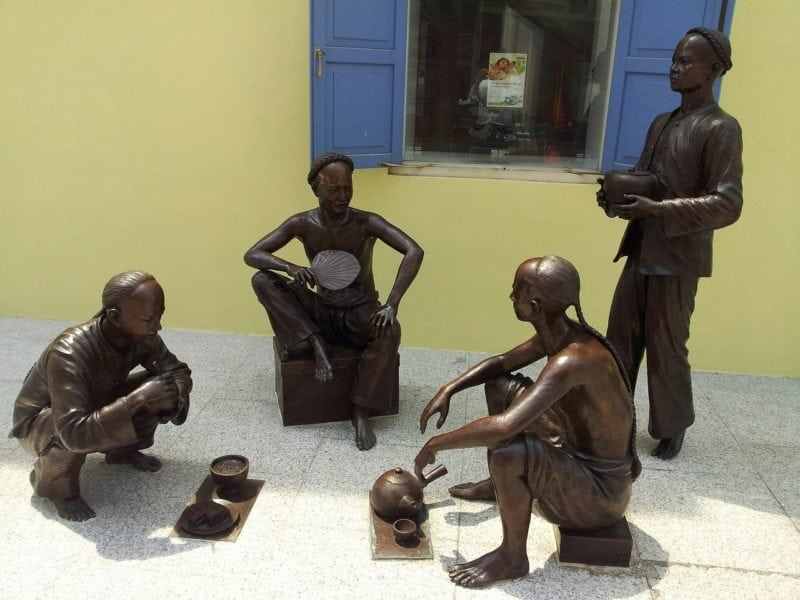Street statues in Singapore showing the old times