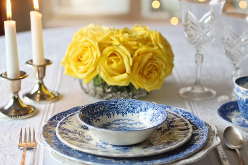 Table setting with yellow flowers at centre