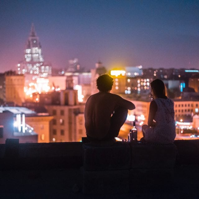 Couple sit outside in a warm night in Moscow
