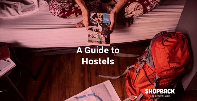 girl holding a travel guide on a hostel dorm
