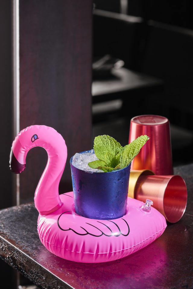 cocktail on a neon pink inflatable buoy